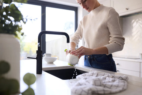 Using filtered water in a modern kitchen to improve water use safety.