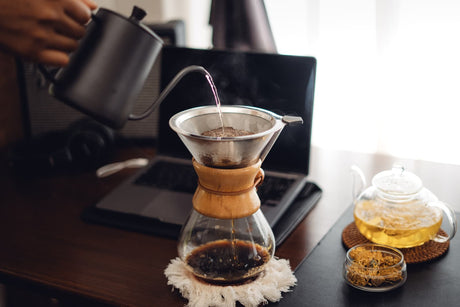 Filtered water carafe beside pour-over coffee and tea brewing tools