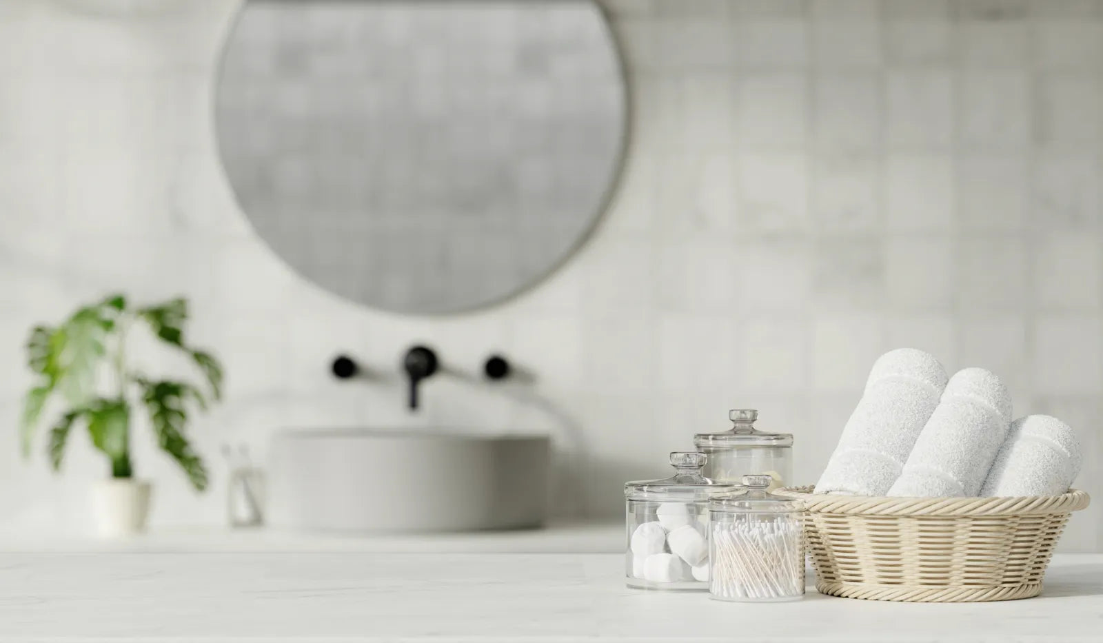 Minimalist bathroom vanity with towels and toiletries, a calm setting to prepare the best water for facial steaming.