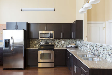 Modern kitchen with refrigerator and sink where an RO water line can be routed to the fridge