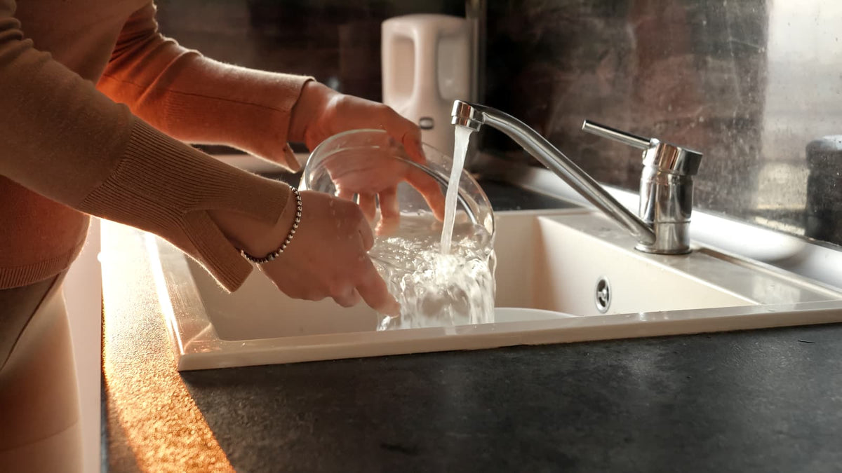 Kitchen faucet and glassware showing a home water-quality and hard-water context.
