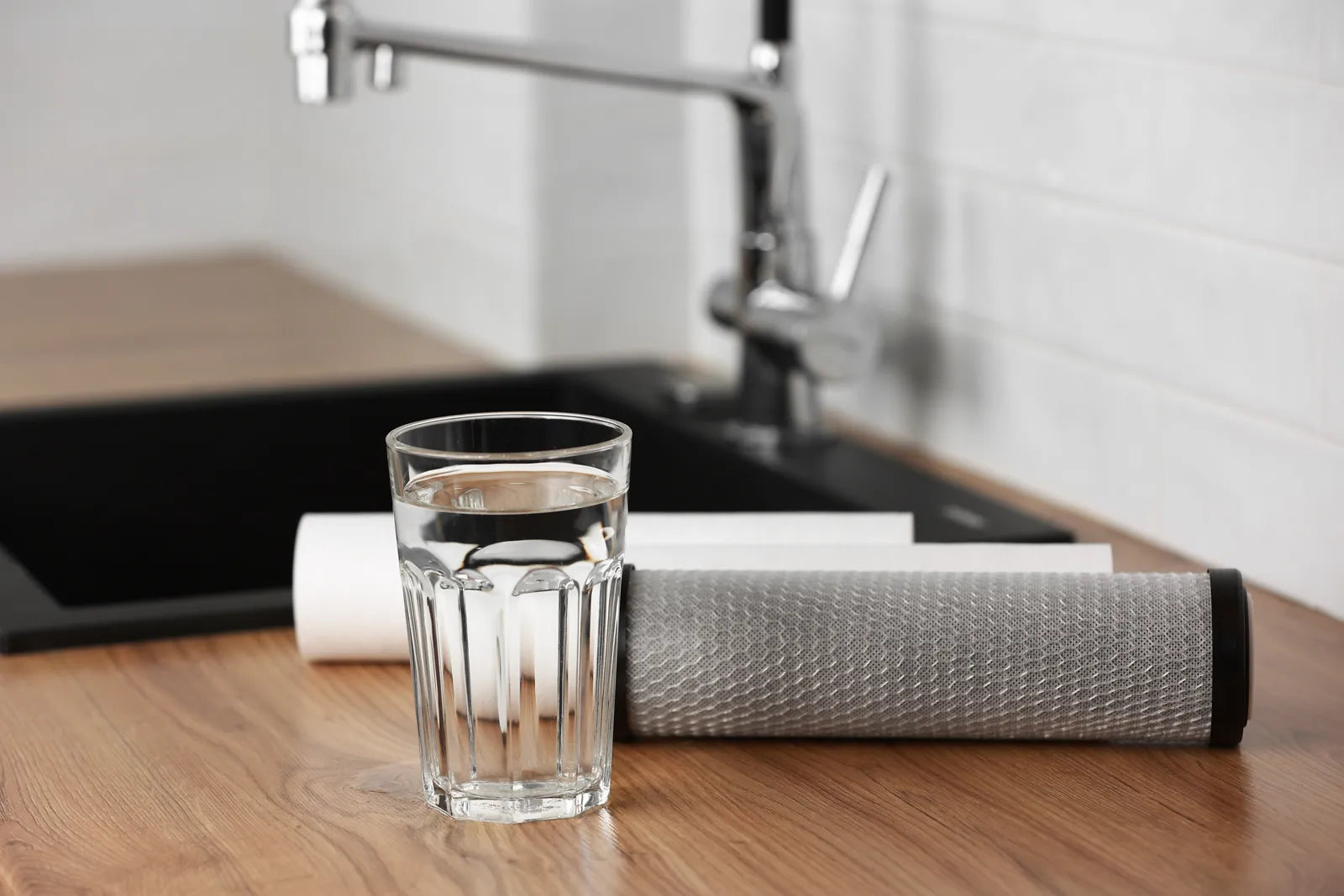 Clean RO filter cartridges sit beside fresh ready-to-drink filtered kitchen water.