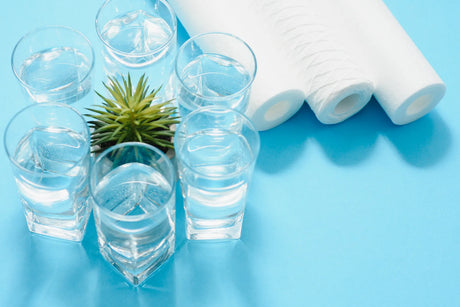 Glasses of purified water and RO filters, showing the source of reusable waste water.