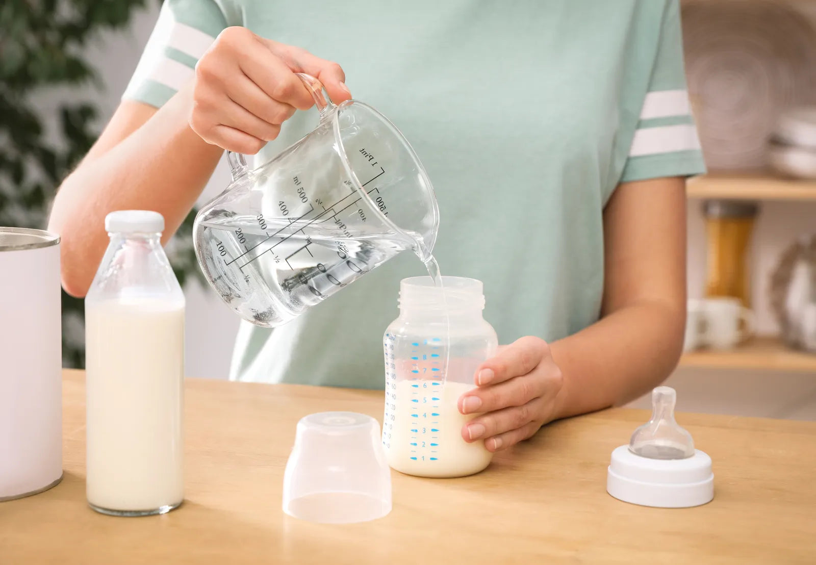 A caregiver prepares baby formula using RO water for infant feeding safety.